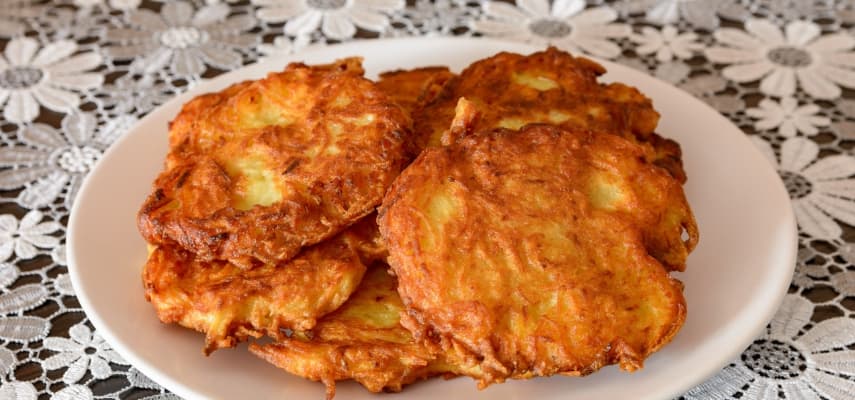 Crisp-edged placki ziemniaczane (Polish potato pancakes) topped with sour cream, a staple at milk bars and mountain restaurants.